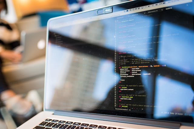 Laptop screen displaying code in an integrated development environment with a blurred background.